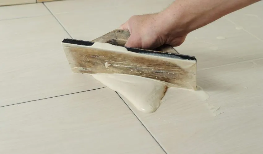 Applying paint remover to strip paint from flooring
