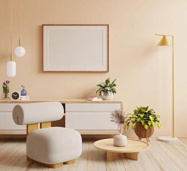 Modern living room with beige chair, plants, and lighting